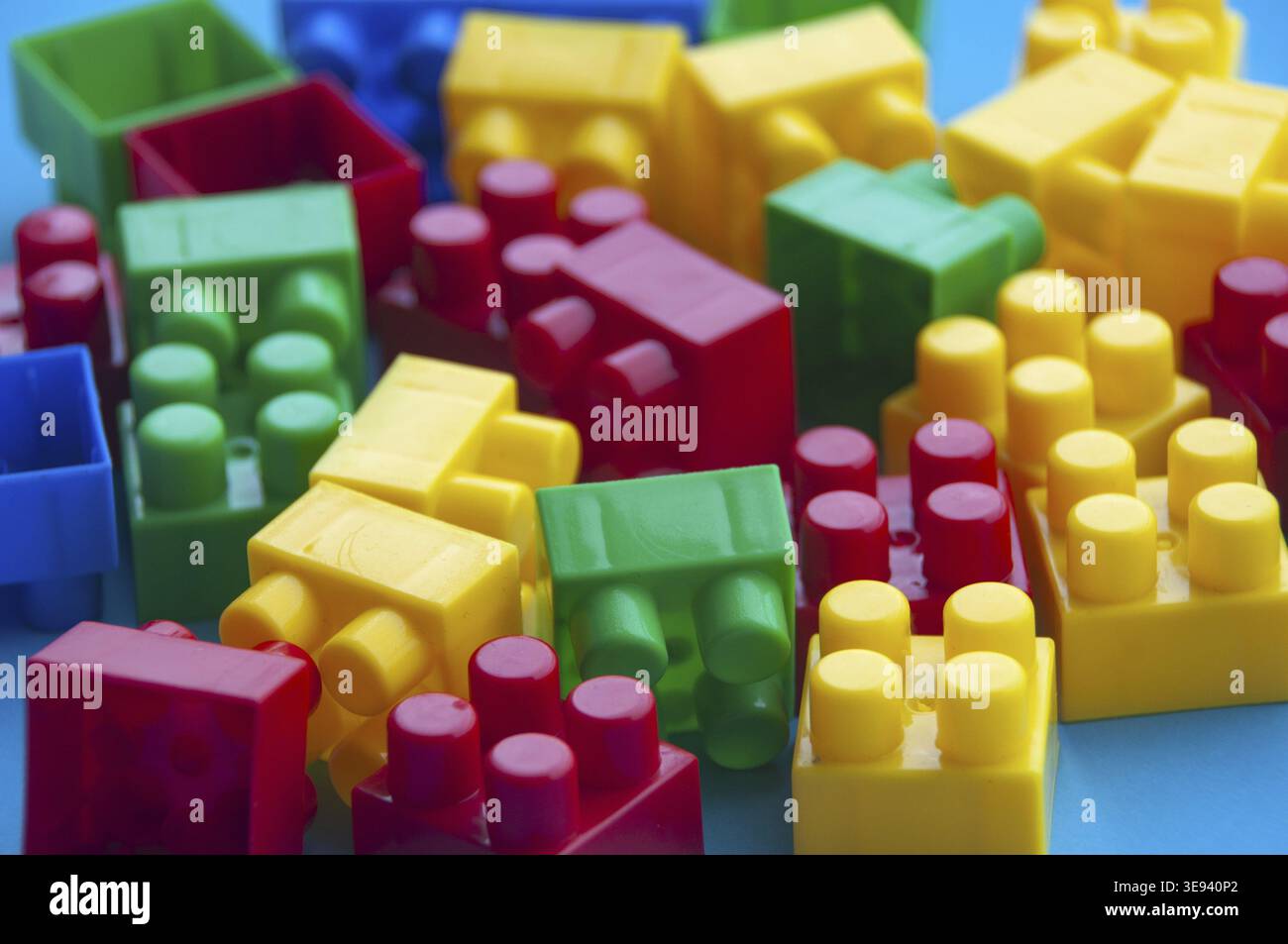 Plastic building blocks on blue background. Educational concept Stock Photo