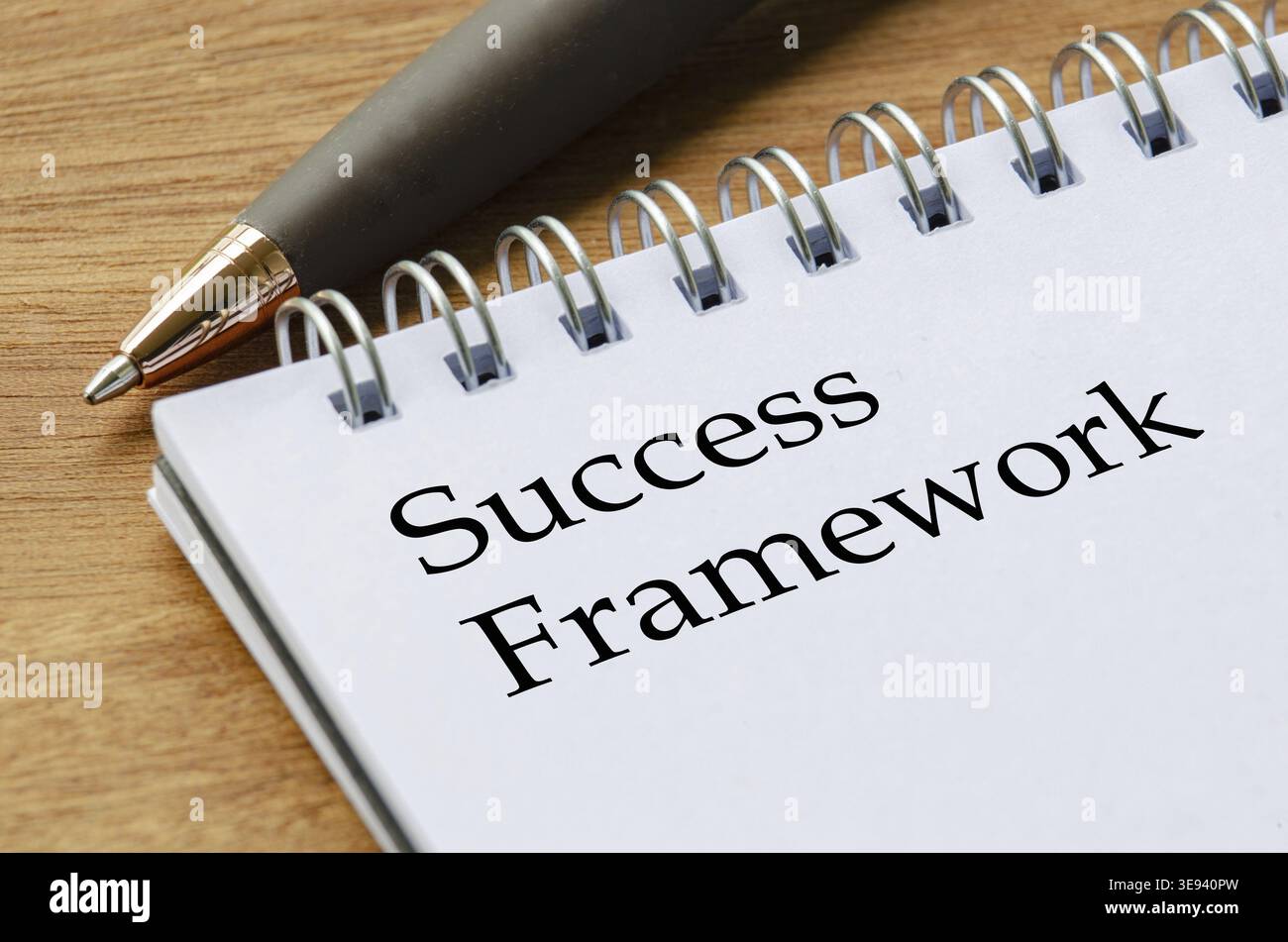 Close up notepad featuring Success Framework text on white lined pages in focus Stock Photo