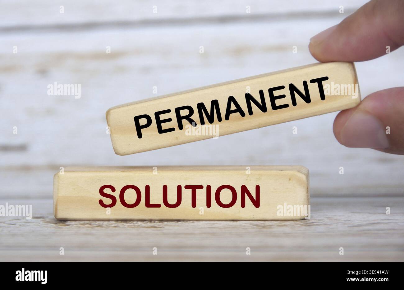 Hand holding wooden blocks with text - Permanent solution. Solution concept Stock Photo