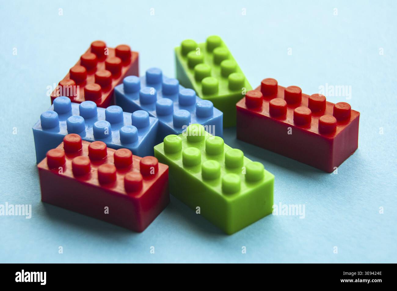 Plastic building blocks on blue background. Copy space Stock Photo