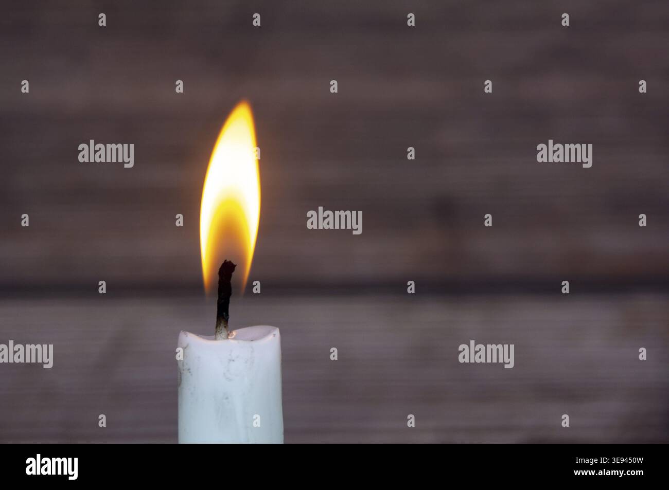 Candle light burning brightly with customizable space for text or ideas. Copy space Stock Photo