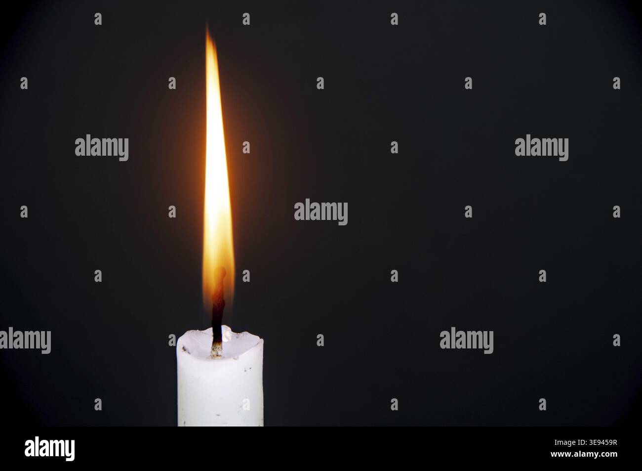 Candle light burning brightly with customizable space for text or ideas. Copy space Stock Photo