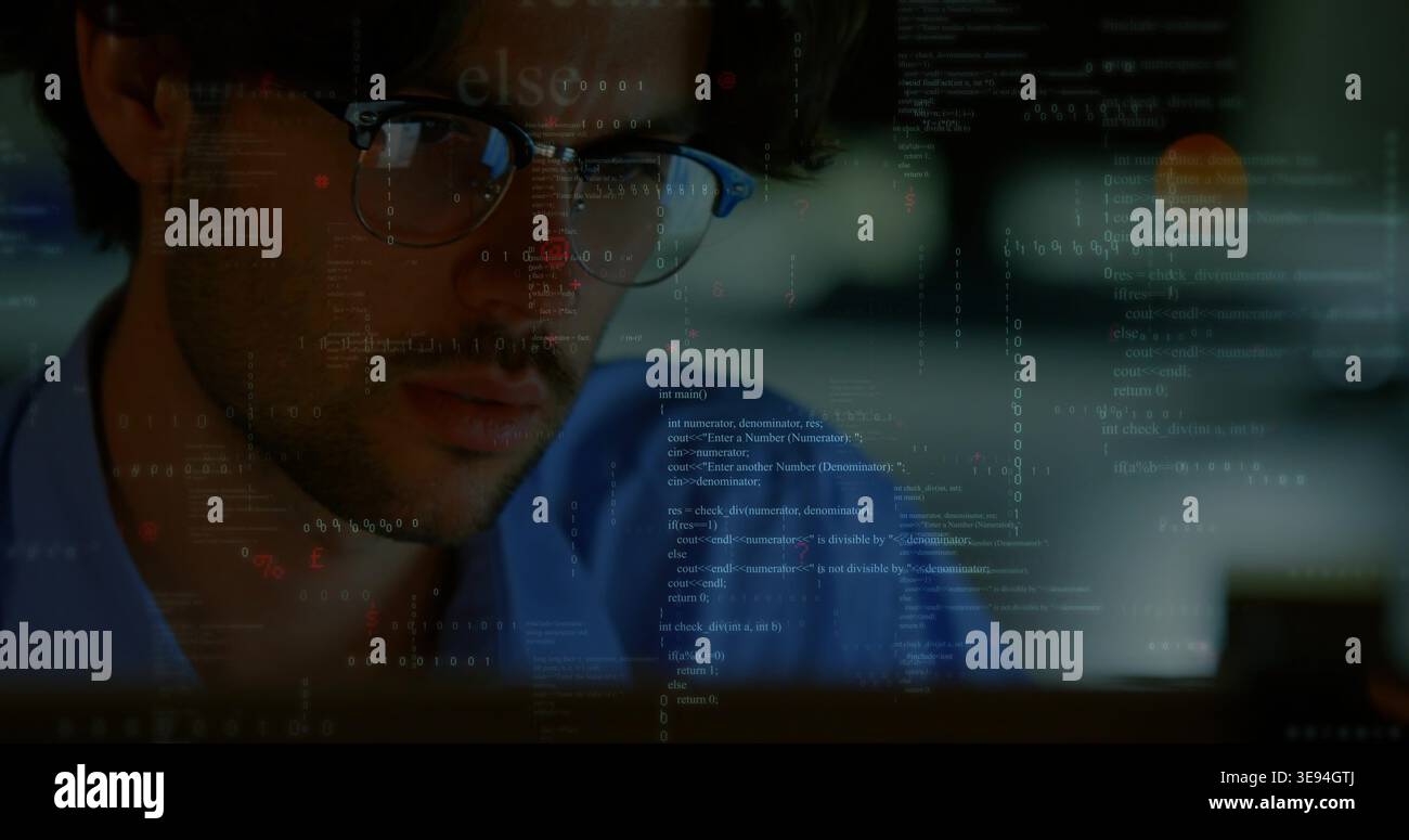 Studying developer focusing on code at dim workstation, wearing blue shirt, glasses reflecting code Stock Photo