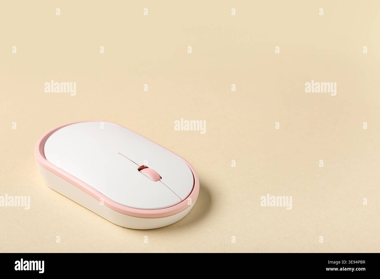 Modern wireless computer mouse on beige background Stock Photo
