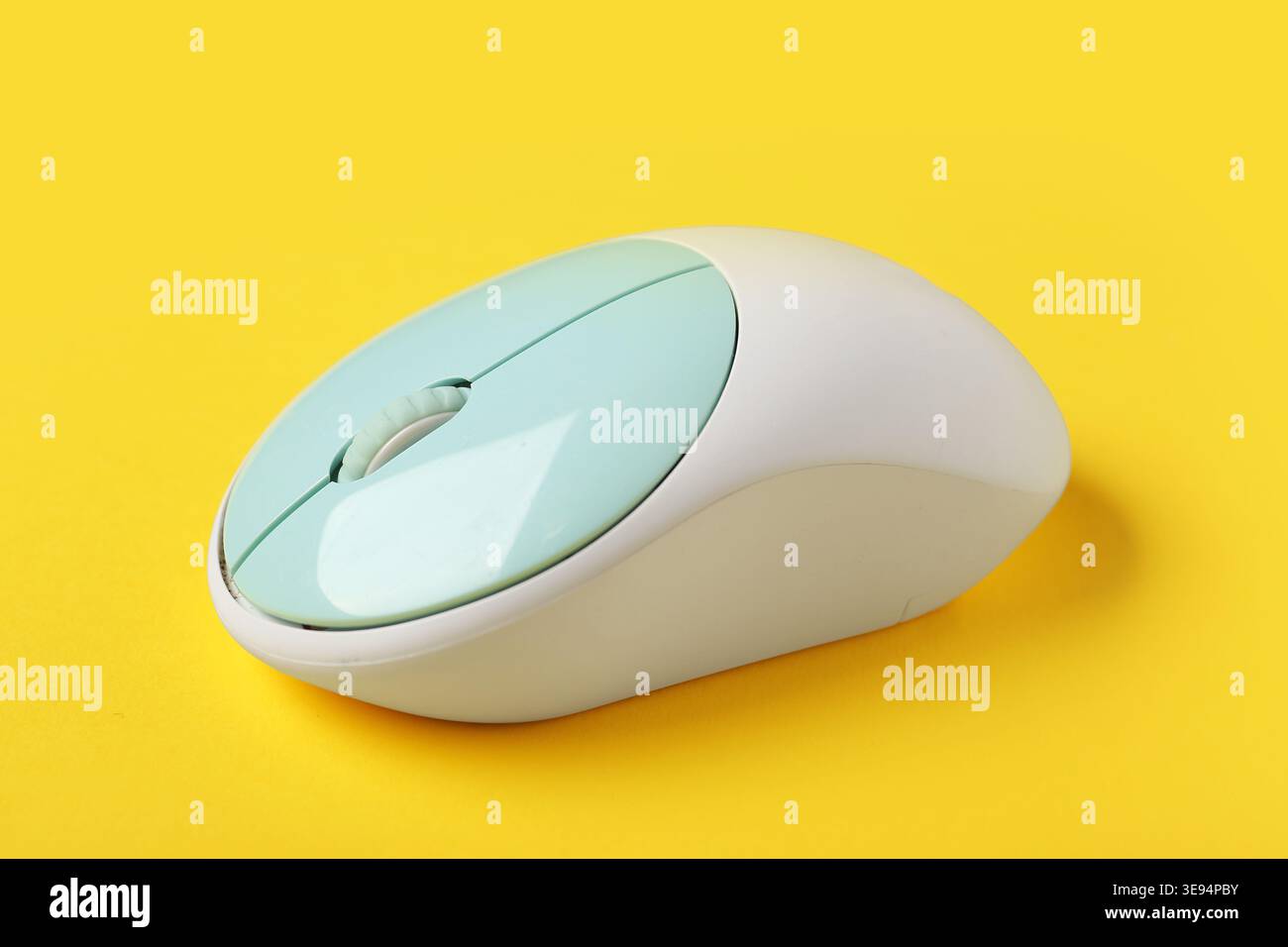 Modern wireless computer mouse on yellow background Stock Photo