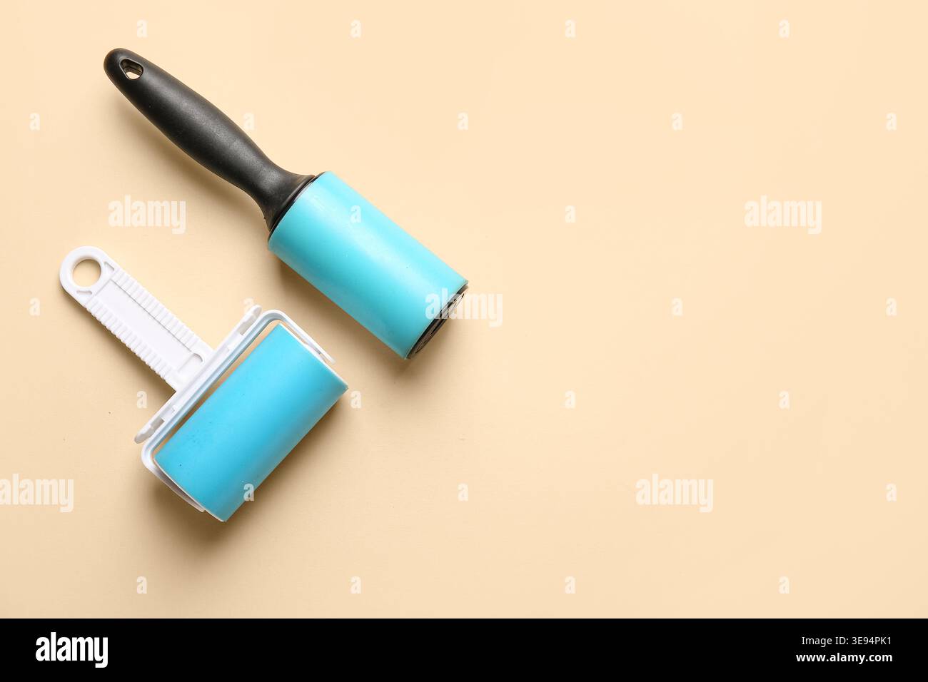 Different lint rollers on beige background Stock Photo