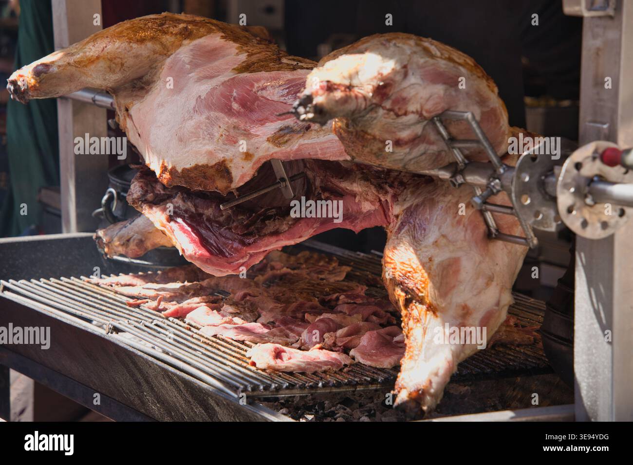 Pig placed on a barbecue, cooking slowly. Stock Photo
