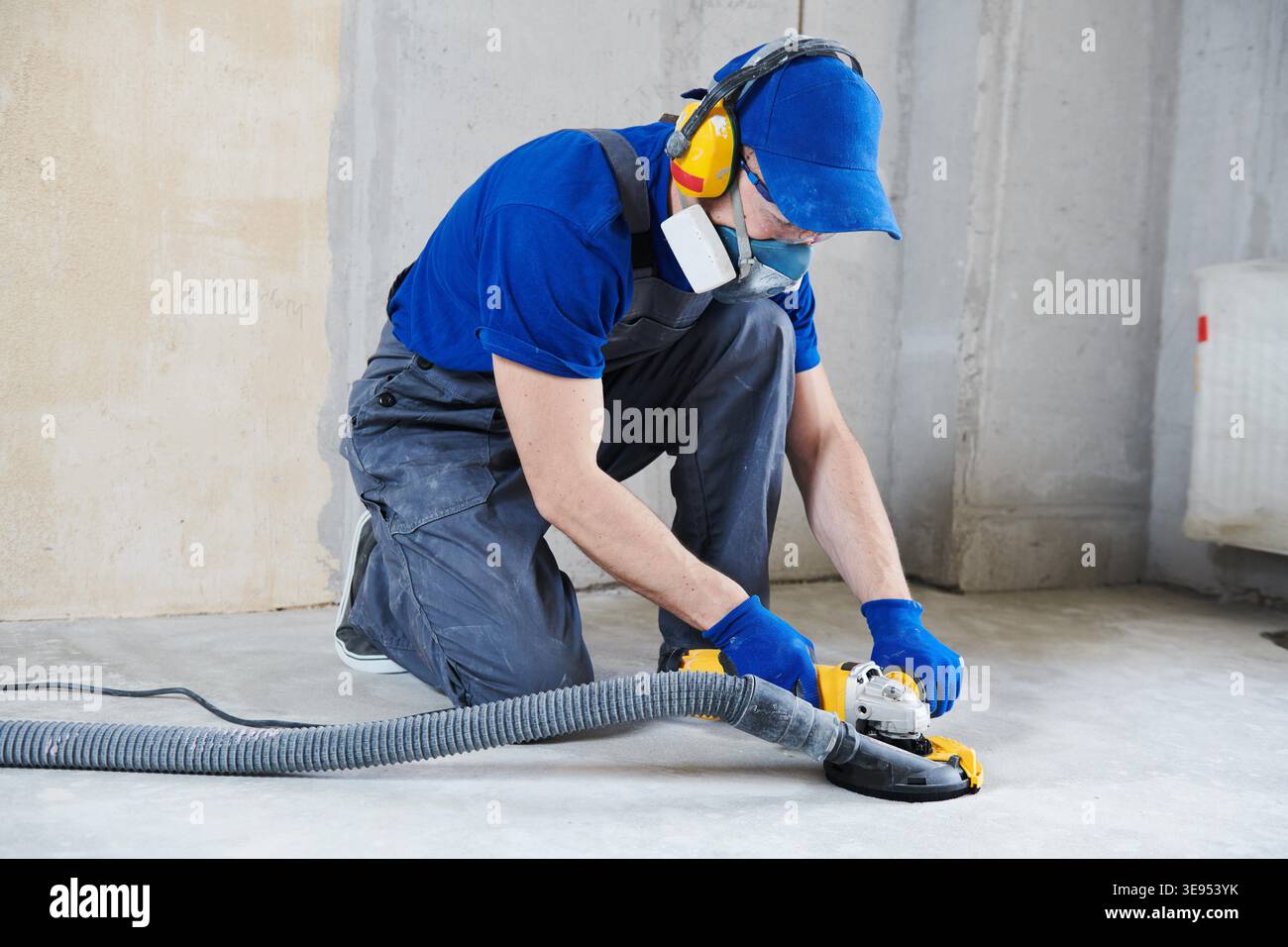 concrete floor surface grinding with diamond cup grinder machine Stock Photo
