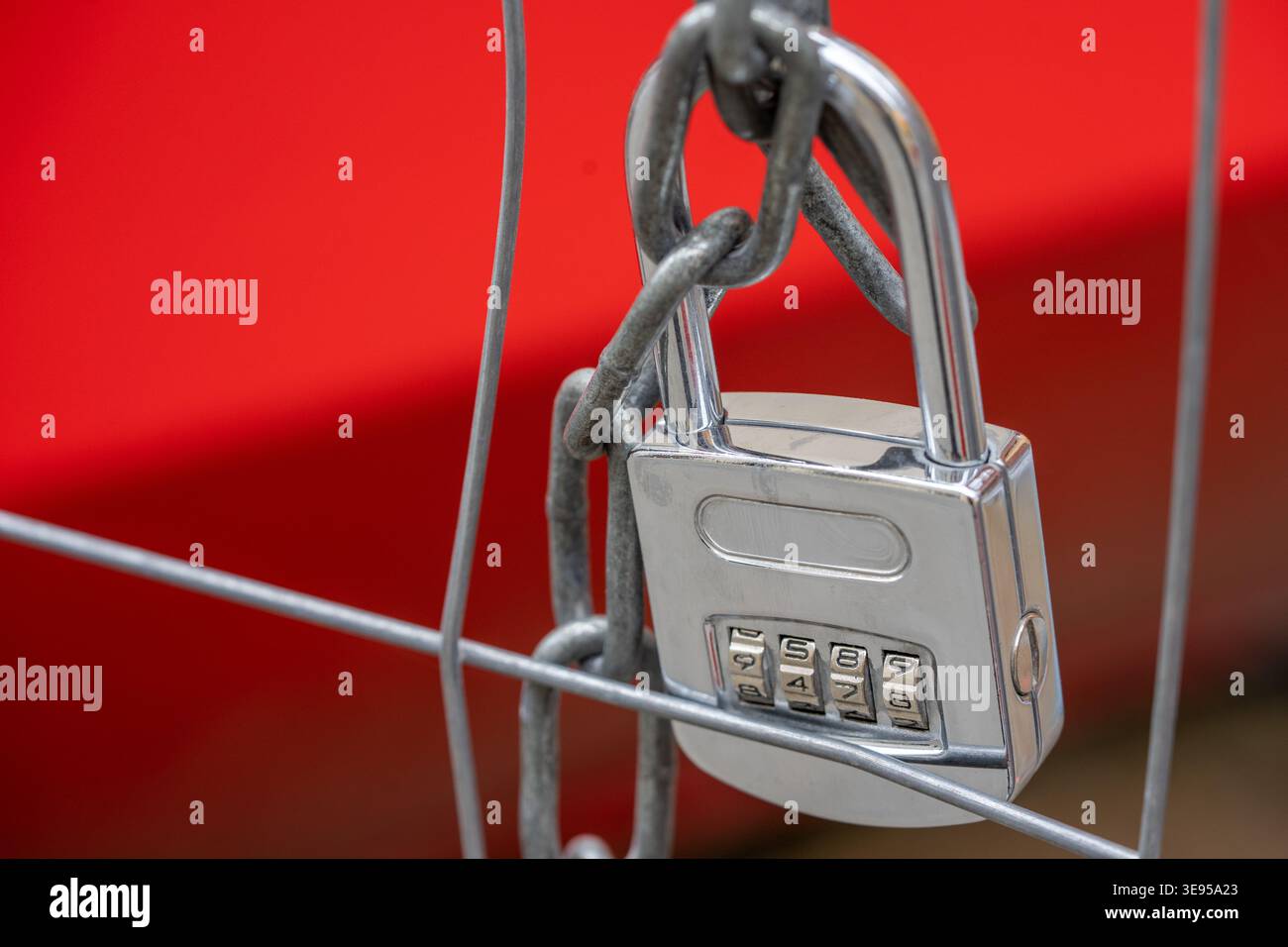 lock with code number and chain on a metal fence Stock Photo