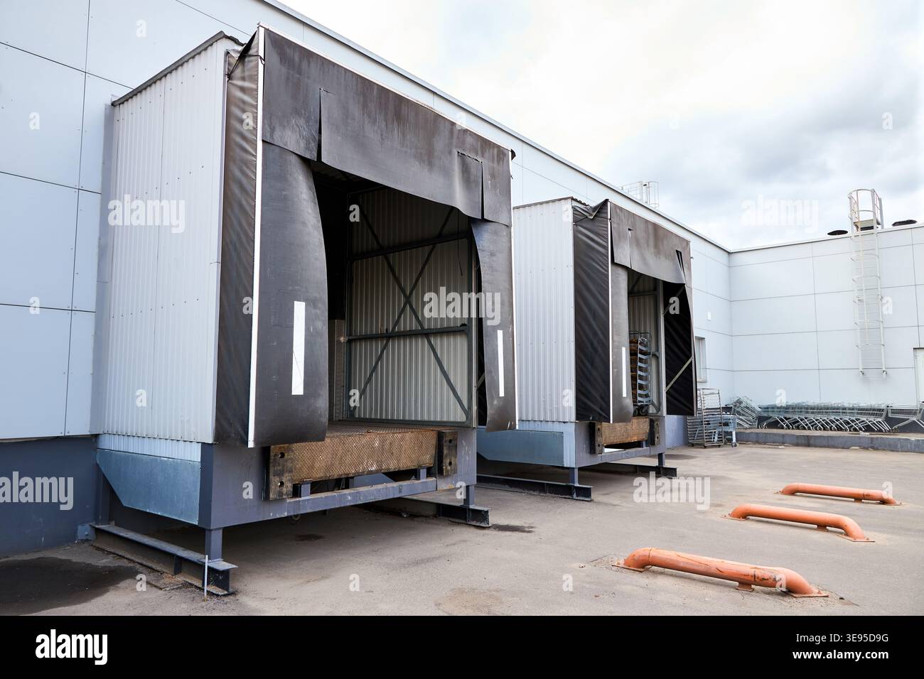 Loading dock or loading bay with bumpers, levelers, lift, dock seals or shelters, traffic lights. Loading bay is area of building where goods vehicles Stock Photo