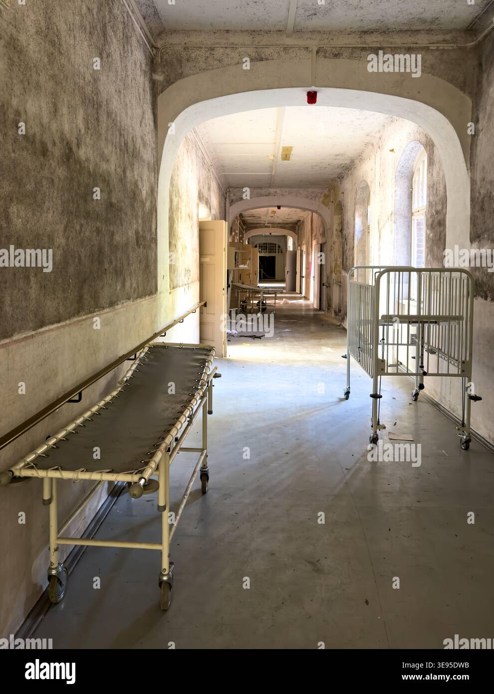 old abandoned Hospital corridor with sick bed in a lost place sanatorium vertical Stock Photo
