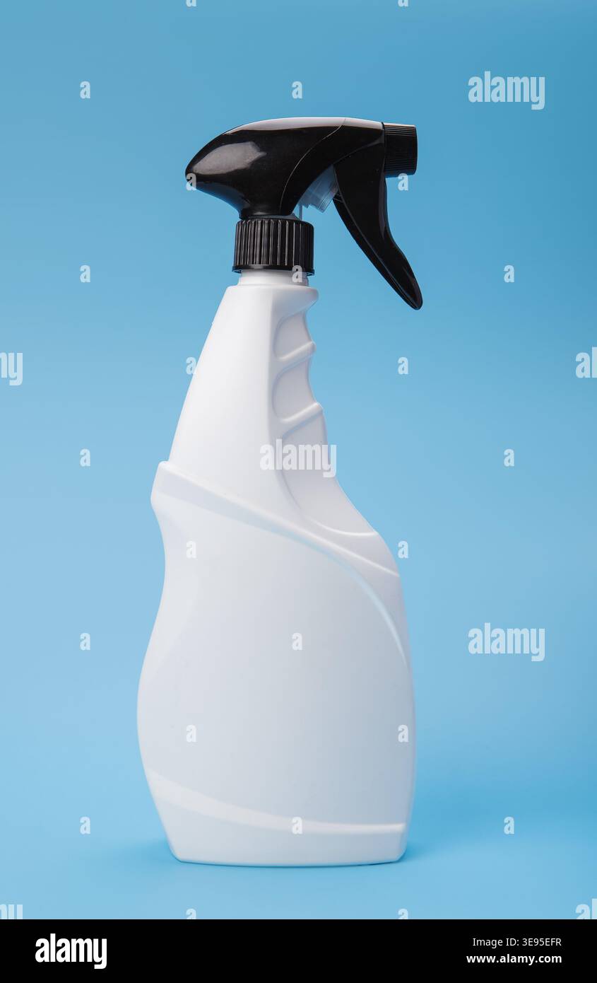 White Trigger Spray Bottle on Blue Background Stock Photo
