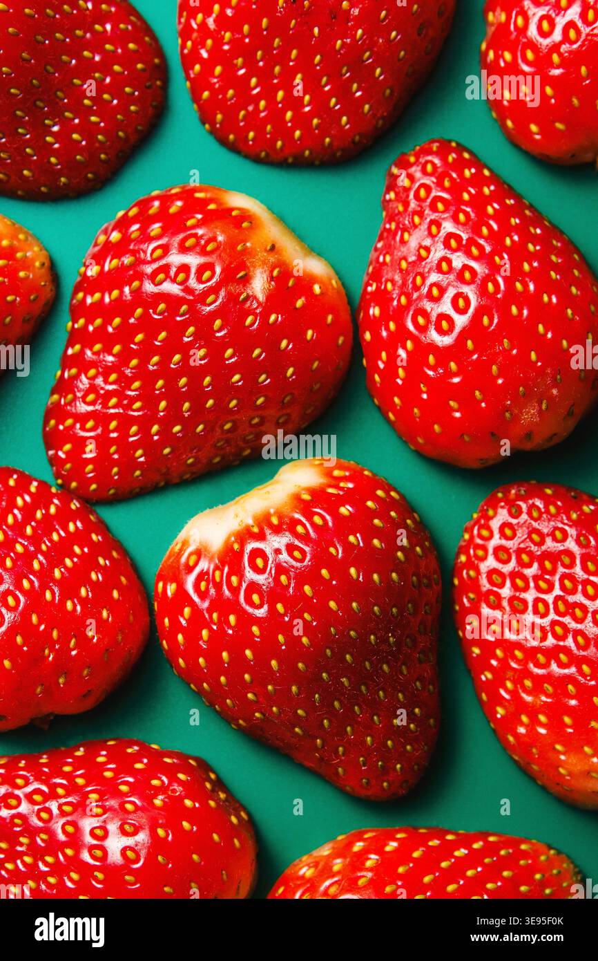 Fresh Strawberries Pattern on Teal Background Stock Photo