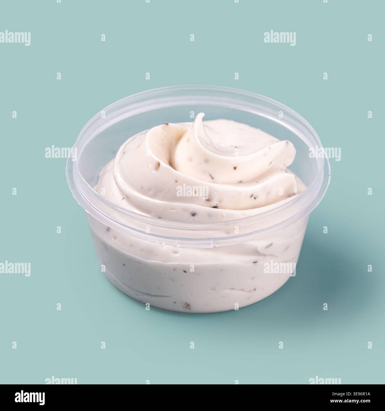 Creamy white sauce in plastic container Stock Photo