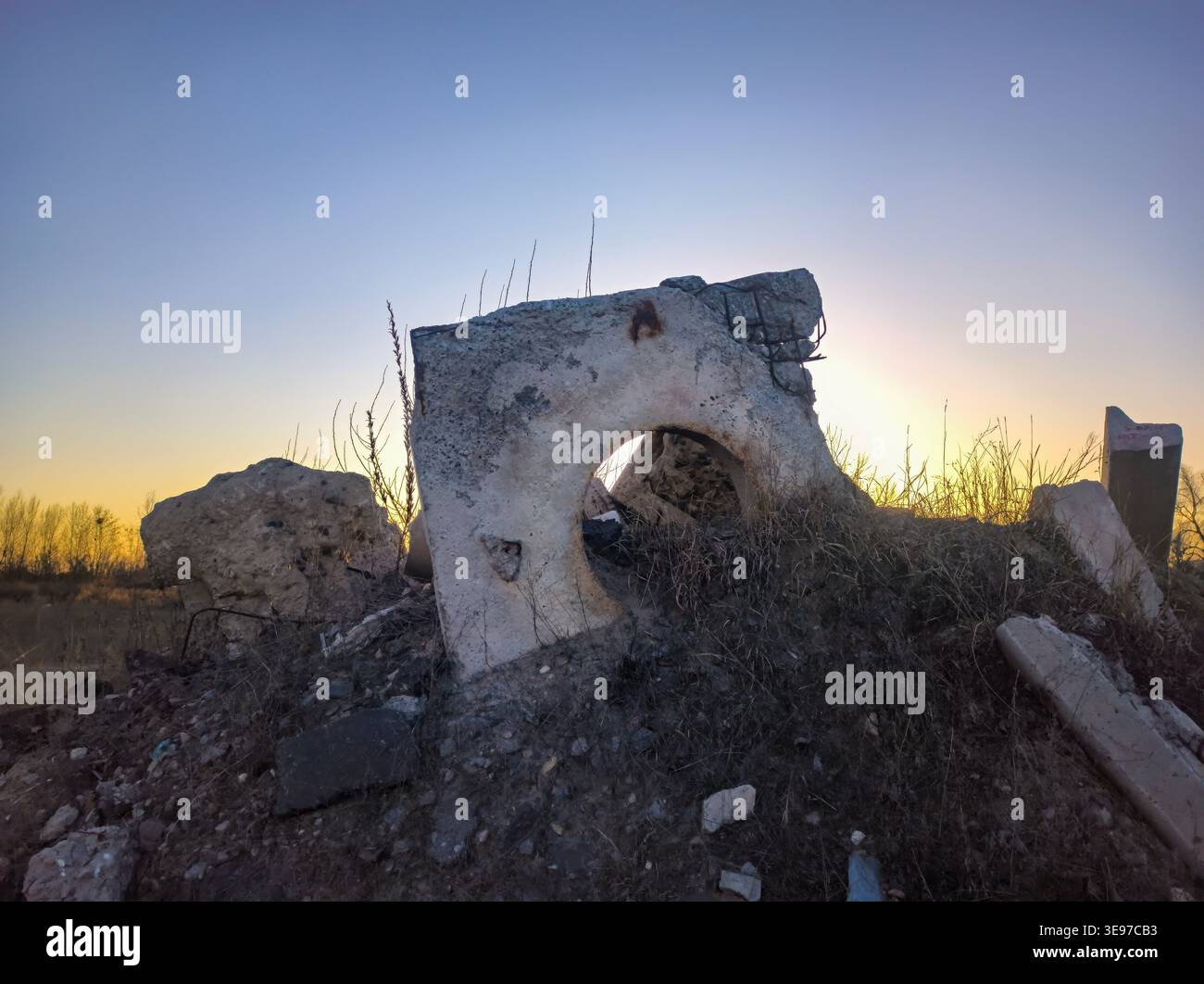 Silent Decayed Landscape. Desolate Building Remains Bathed In Soft Evening Light Symbolizing Neglect Stock Photo