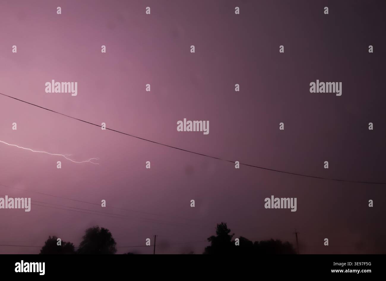 Real lightning strike in the purple night sky during a summer ...