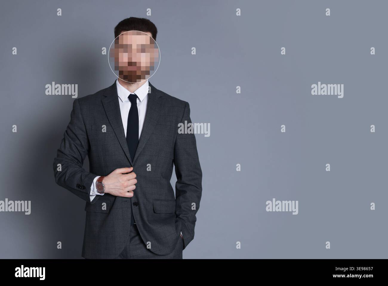Anonymous man with pixelated face on grey background Stock Photo