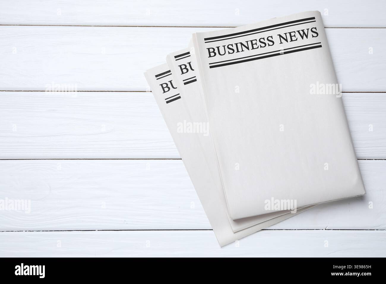 Folded newspapers on white wooden background, top view Stock Photo