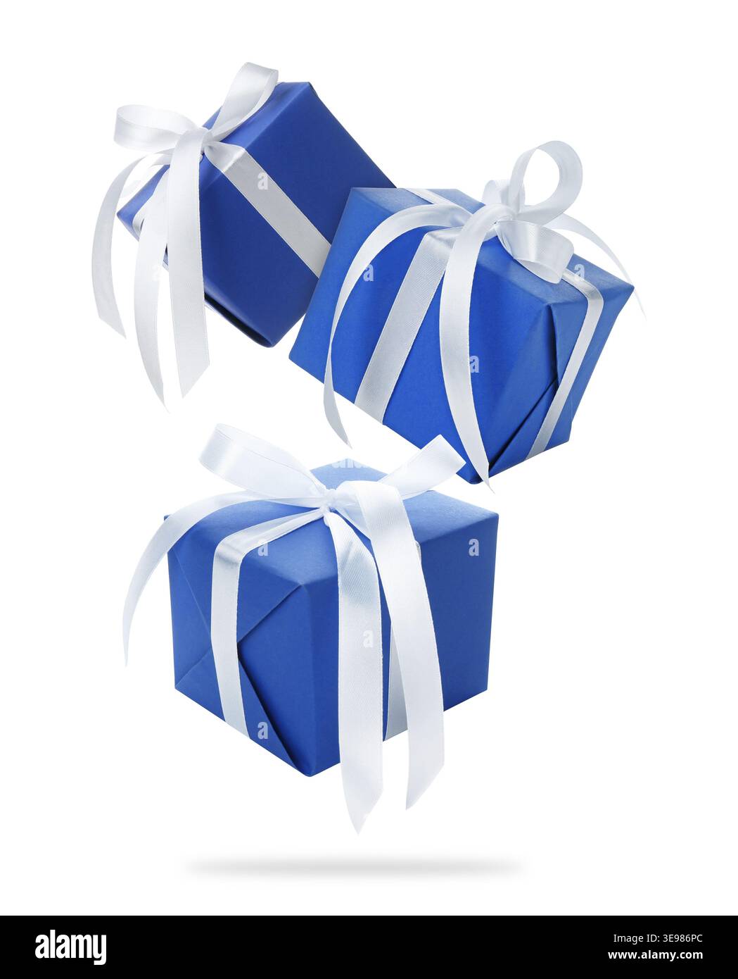 Gift boxes flying in air against white background Stock Photo