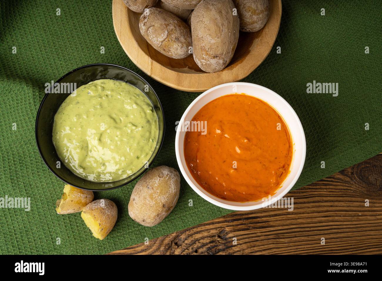 Red mojo rojo and green mojo verde sauces, traditional Tenerife dips, mojo picon dressing, Canary Islands Papas arrugadas sea water boiled potatoes, S Stock Photo