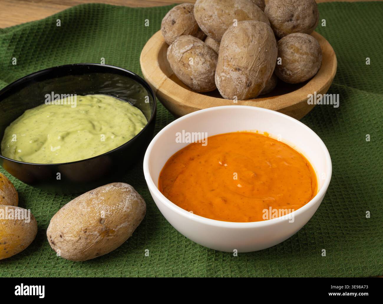 Red mojo rojo and green mojo verde sauces, traditional Tenerife dips, mojo picon dressing, Canary Islands Papas arrugadas sea water boiled potatoes, S Stock Photo