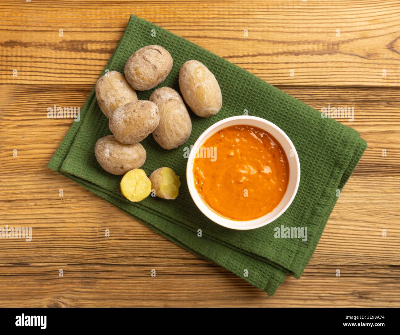 Red mojo rojo and green mojo verde sauces, traditional Tenerife dips, mojo picon dressing, Canary Islands Papas arrugadas sea water boiled potatoes, S Stock Photo