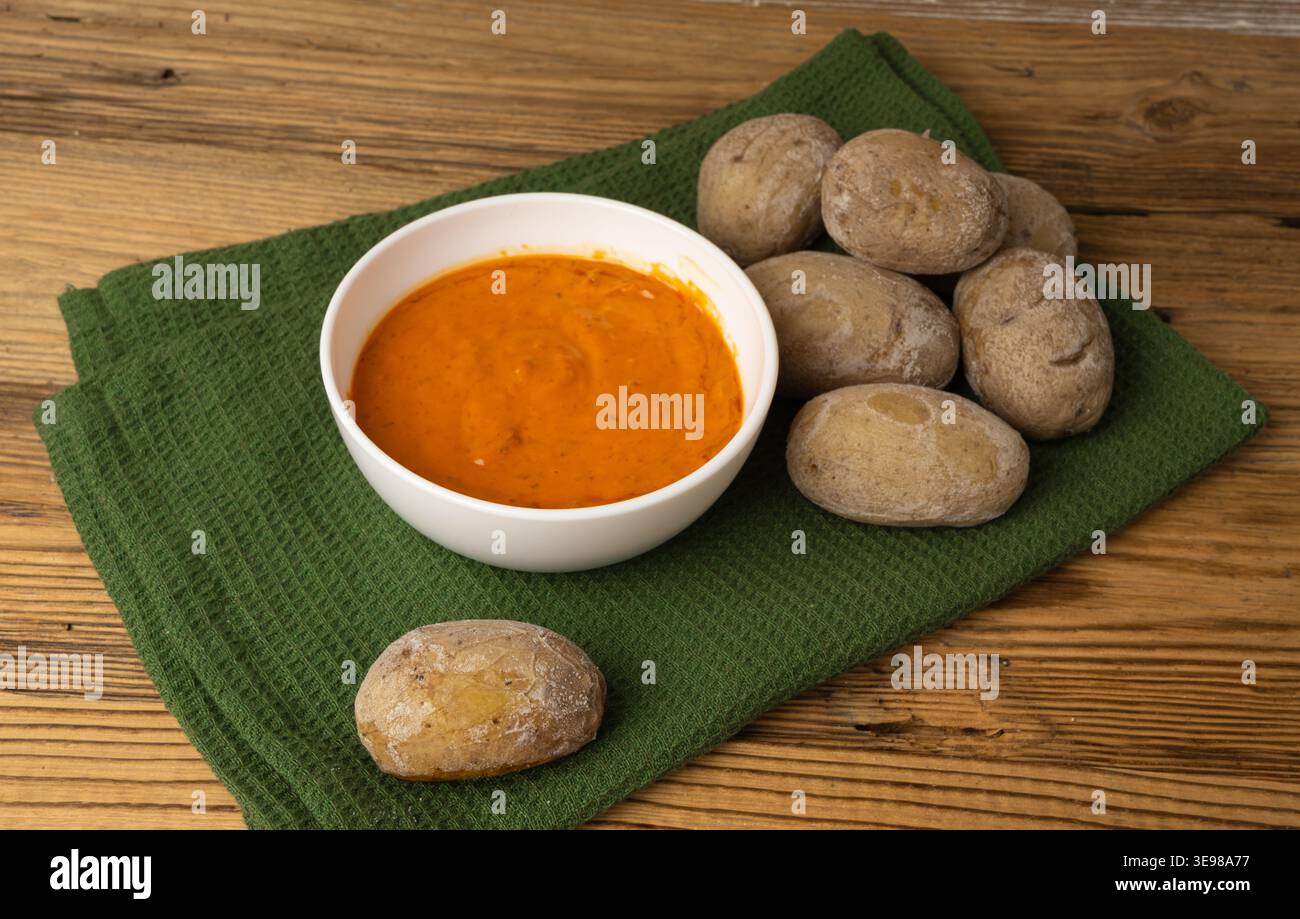 Red mojo rojo and green mojo verde sauces, traditional Tenerife dips, mojo picon dressing, Canary Islands Papas arrugadas sea water boiled potatoes, S Stock Photo