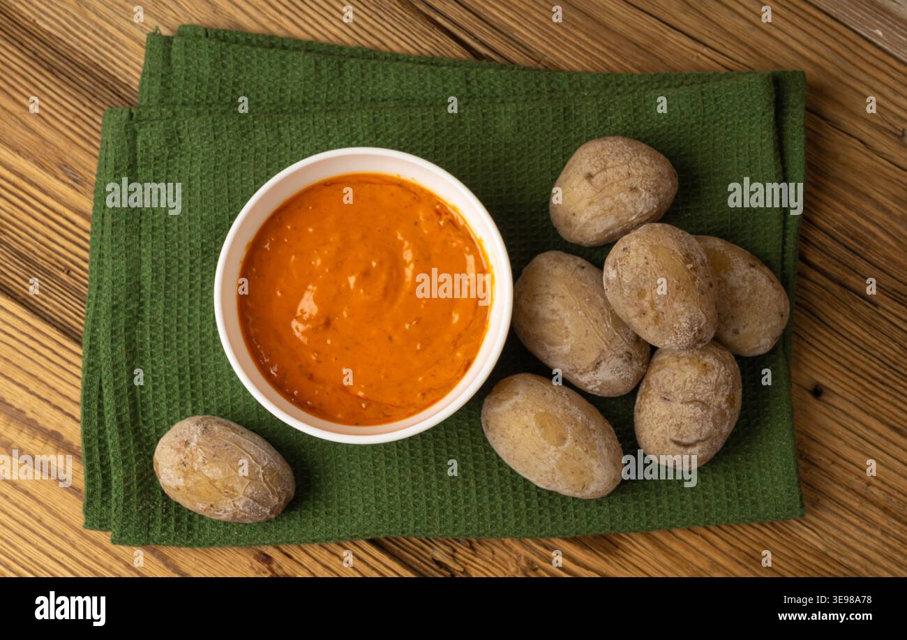 Red mojo rojo and green mojo verde sauces, traditional Tenerife dips, mojo picon dressing, Canary Islands Papas arrugadas sea water boiled potatoes, S Stock Photo