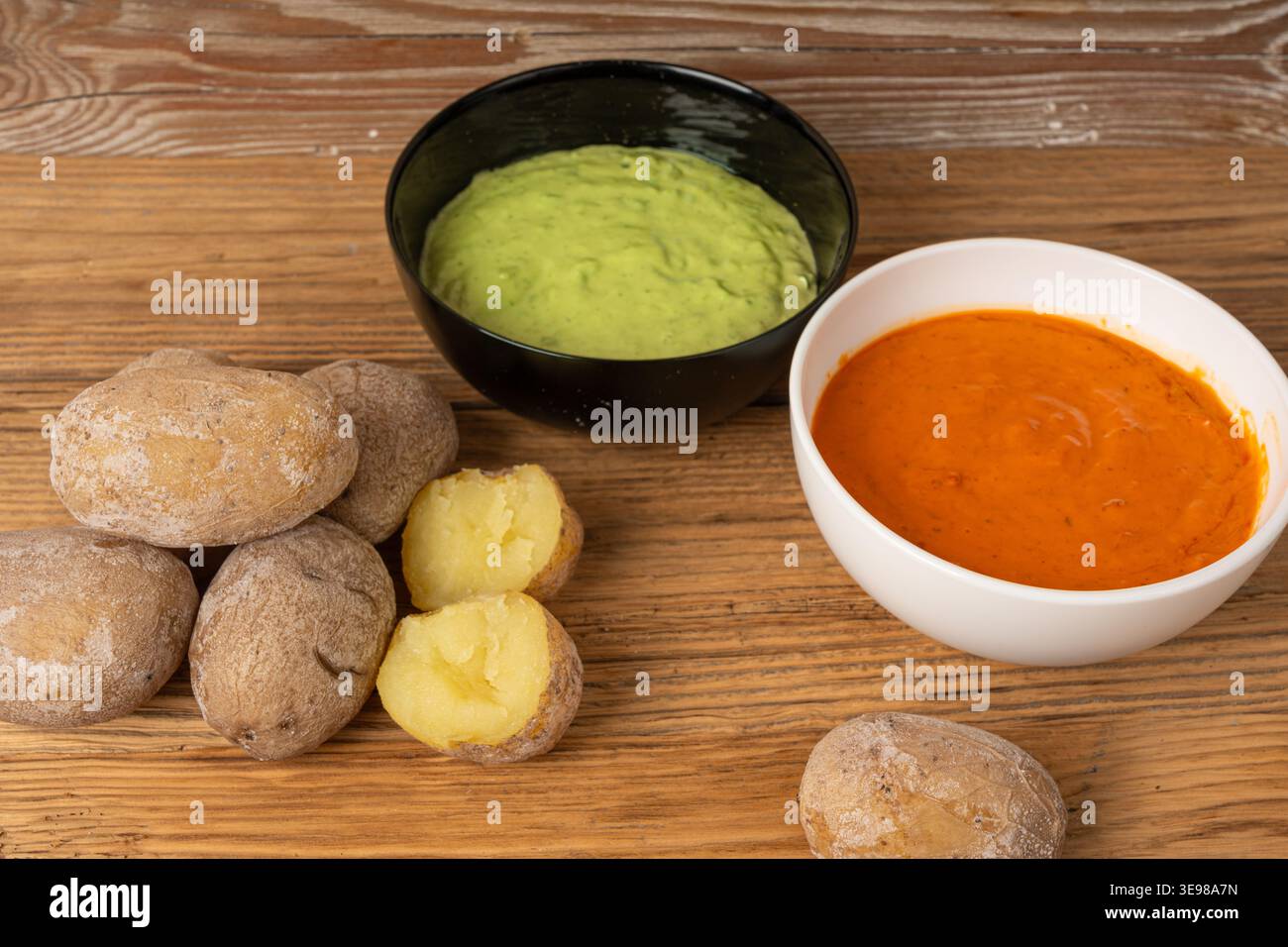 Red mojo rojo and green mojo verde sauces, traditional Tenerife dips, mojo picon dressing, Canary Islands Papas arrugadas sea water boiled potatoes, S Stock Photo