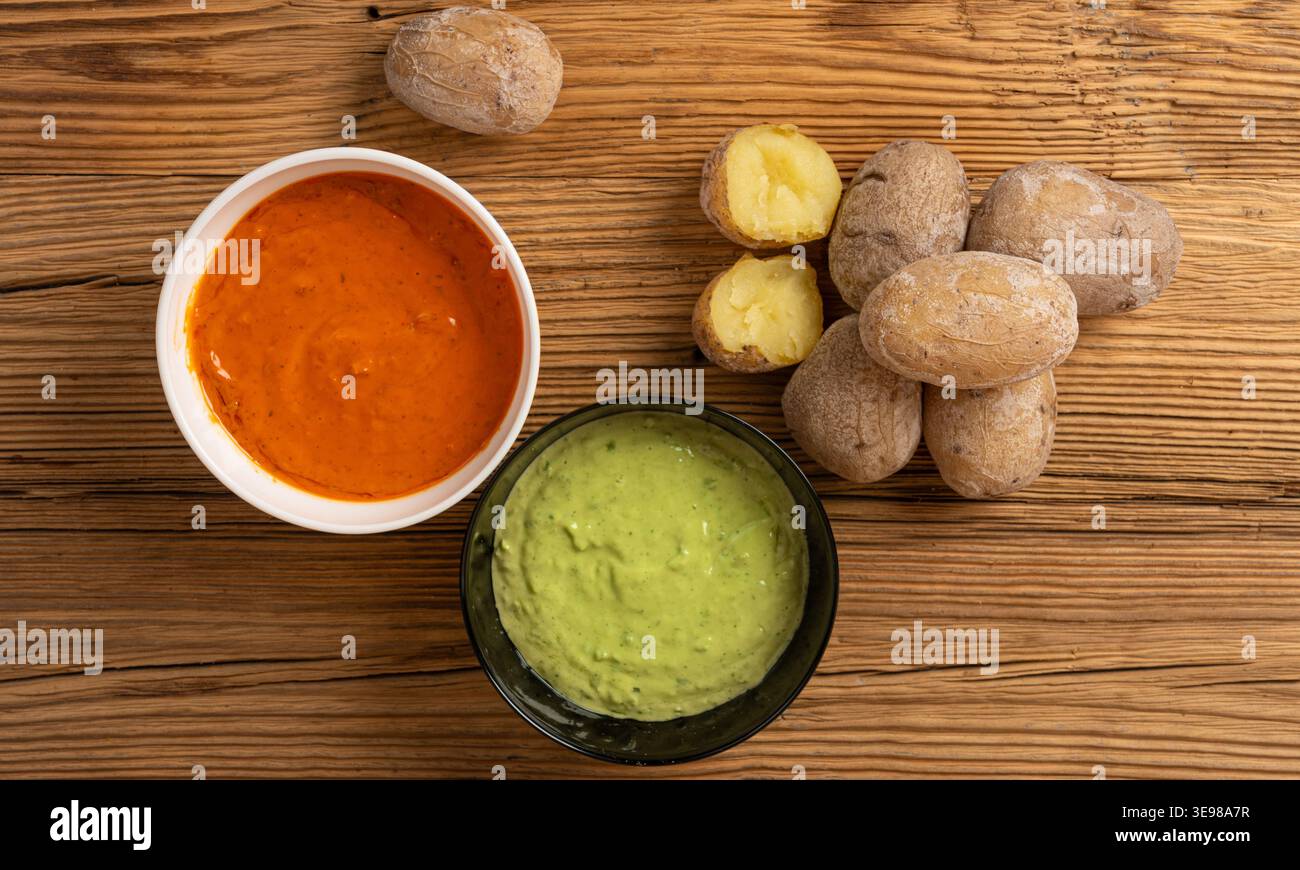 Red mojo rojo and green mojo verde sauces, traditional Tenerife dips, mojo picon dressing, Canary Islands Papas arrugadas sea water boiled potatoes, S Stock Photo