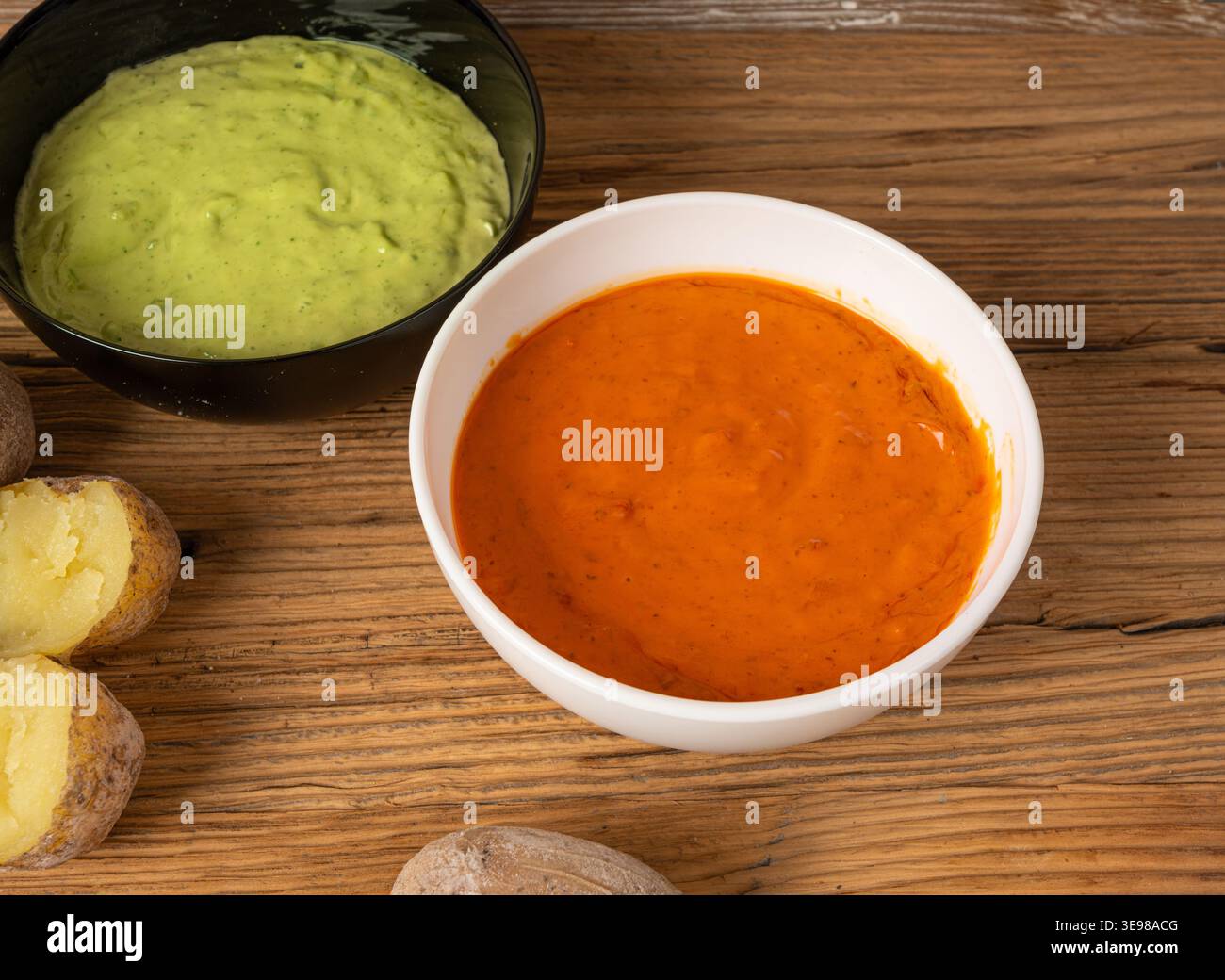 Red mojo rojo and green mojo verde sauces, traditional Tenerife dips, mojo picon dressing, Canary Islands Papas arrugadas sea water boiled potatoes, S Stock Photo