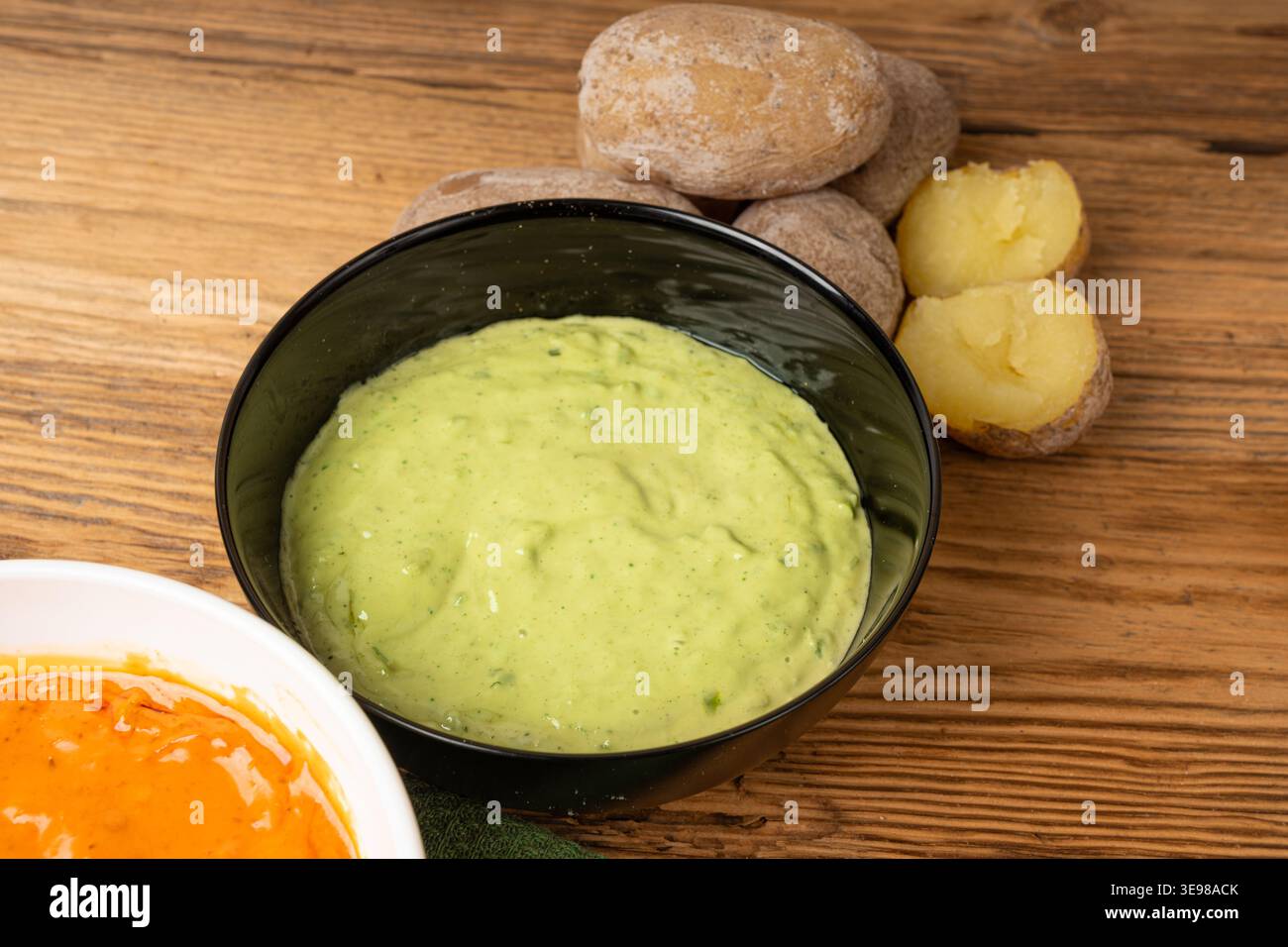 Red mojo rojo and green mojo verde sauces, traditional Tenerife dips, mojo picon dressing, Canary Islands Papas arrugadas sea water boiled potatoes, S Stock Photo