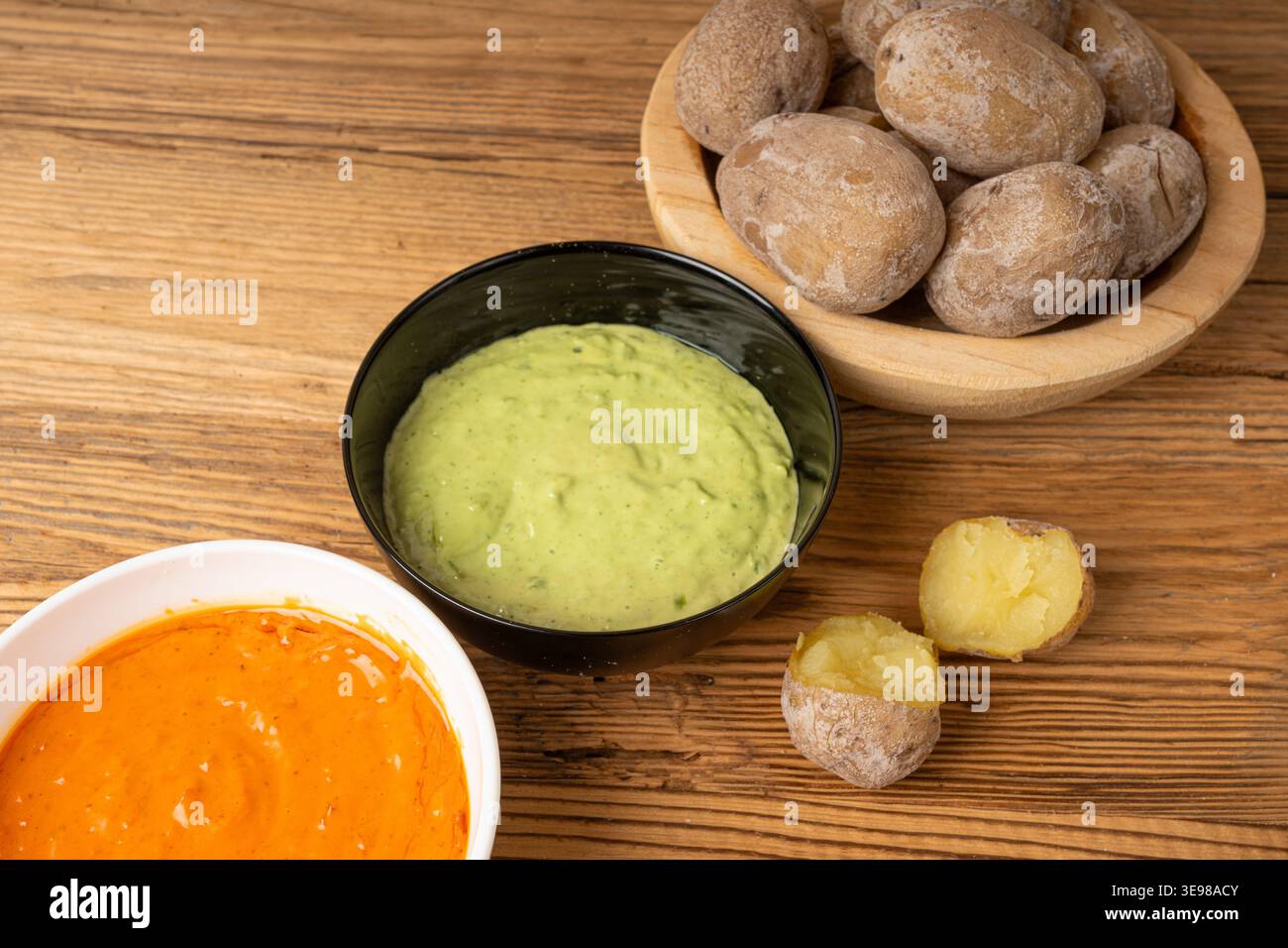 Red mojo rojo and green mojo verde sauces, traditional Tenerife dips, mojo picon dressing, Canary Islands Papas arrugadas sea water boiled potatoes, S Stock Photo