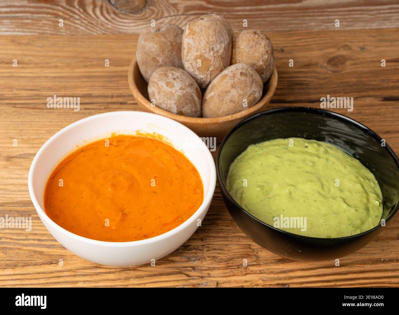 Red mojo rojo and green mojo verde sauces, traditional Tenerife dips, mojo picon dressing, Canary Islands Papas arrugadas sea water boiled potatoes, S Stock Photo