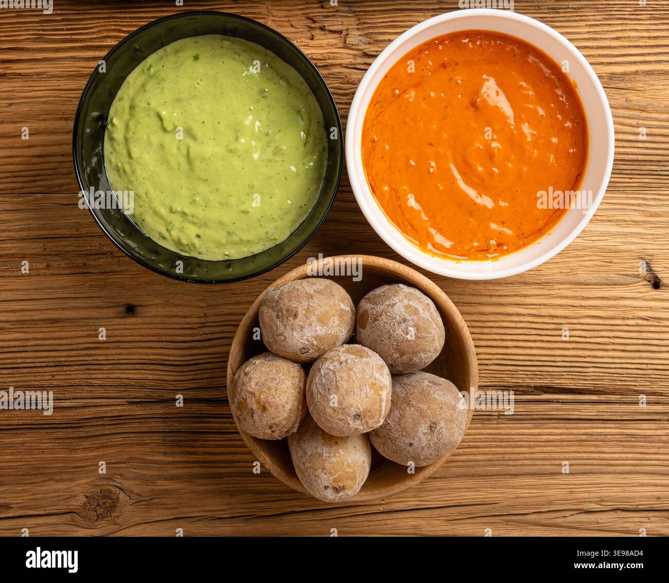 Red mojo rojo and green mojo verde sauces, traditional Tenerife dips, mojo picon dressing, Canary Islands Papas arrugadas sea water boiled potatoes, S Stock Photo