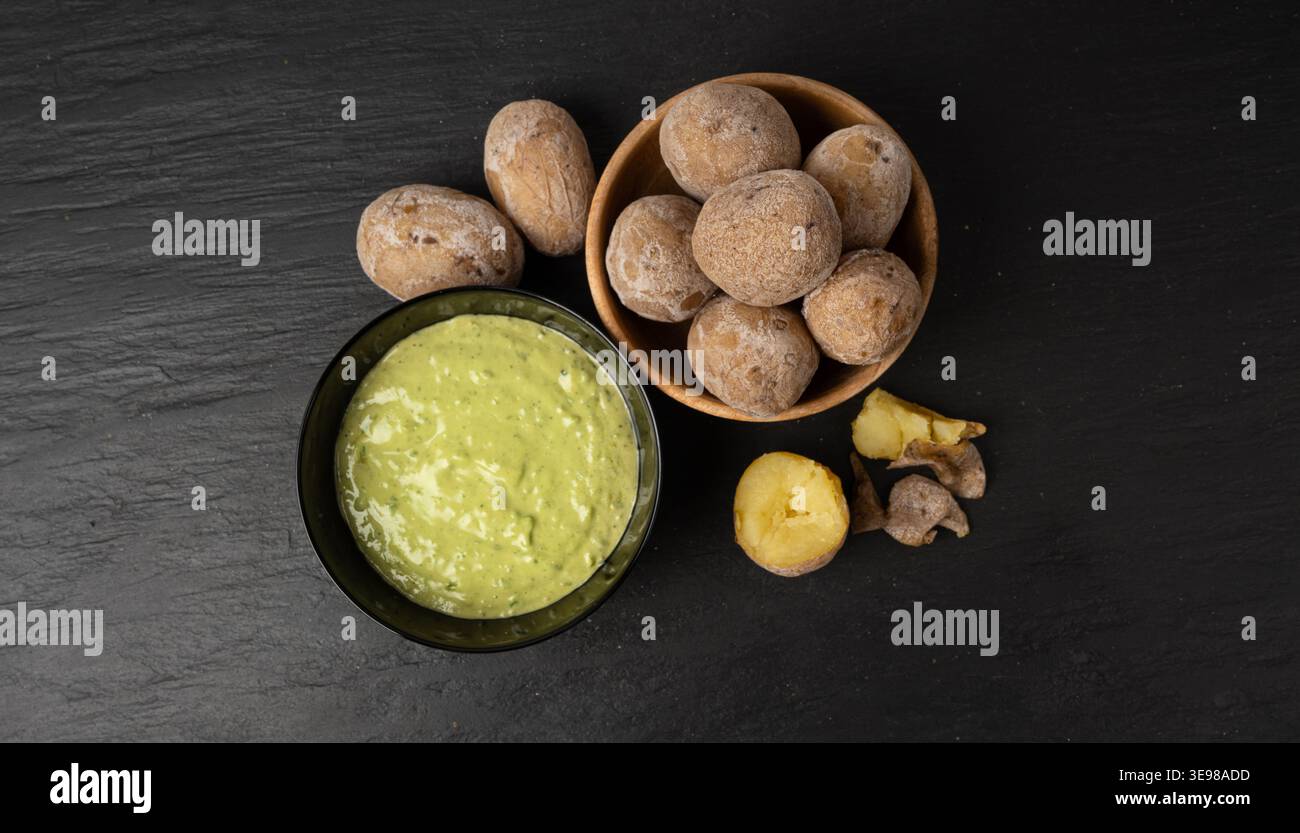 Red mojo rojo and green mojo verde sauces, traditional Tenerife dips, mojo picon dressing, Canary Islands Papas arrugadas sea water boiled potatoes, S Stock Photo