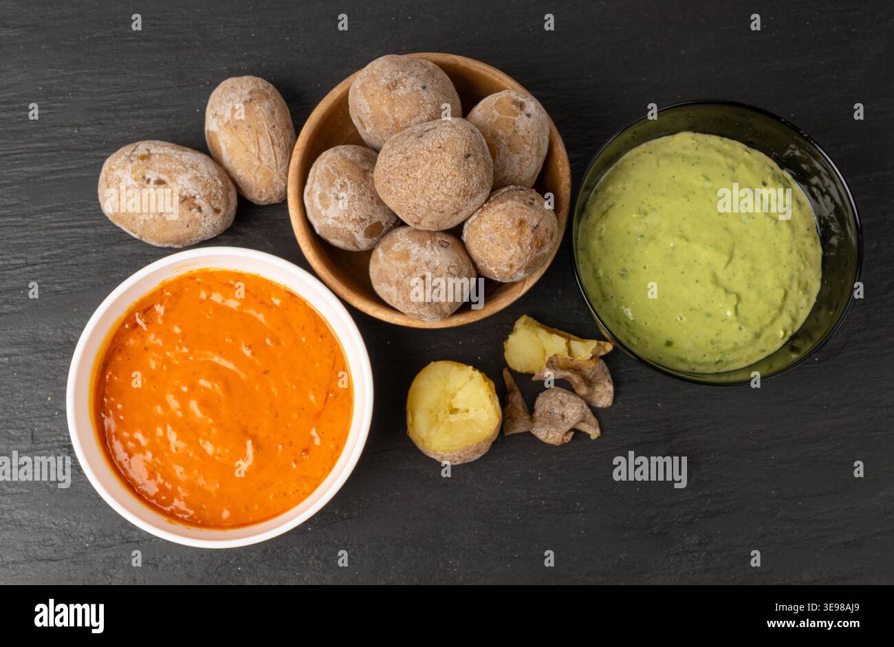 Red mojo rojo and green mojo verde sauces, traditional Tenerife dips, mojo picon dressing, Canary Islands Papas arrugadas sea water boiled potatoes, S Stock Photo