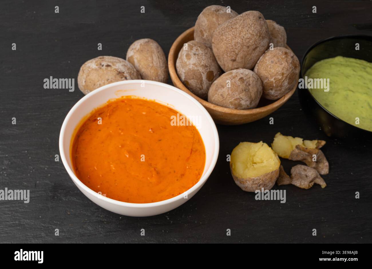 Red mojo rojo and green mojo verde sauces, traditional Tenerife dips, mojo picon dressing, Canary Islands Papas arrugadas sea water boiled potatoes, S Stock Photo