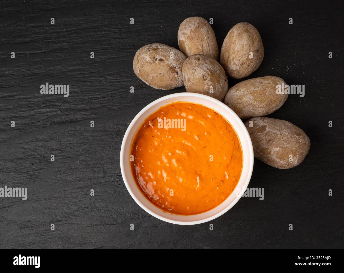 Red mojo rojo and green mojo verde sauces, traditional Tenerife dips, mojo picon dressing, Canary Islands Papas arrugadas sea water boiled potatoes, S Stock Photo