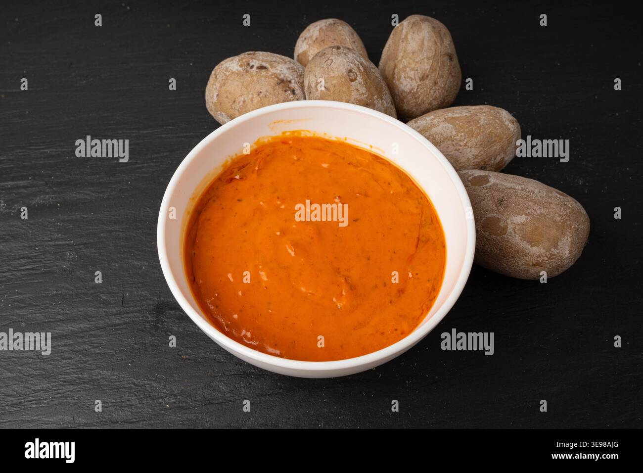 Red mojo rojo and green mojo verde sauces, traditional Tenerife dips, mojo picon dressing, Canary Islands Papas arrugadas sea water boiled potatoes, S Stock Photo