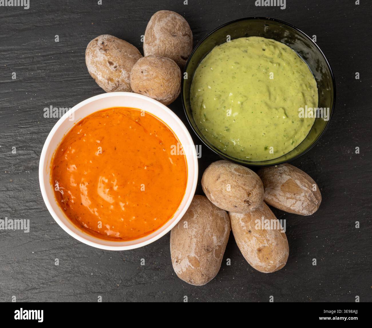 Red mojo rojo and green mojo verde sauces, traditional Tenerife dips, mojo picon dressing, Canary Islands Papas arrugadas sea water boiled potatoes, S Stock Photo