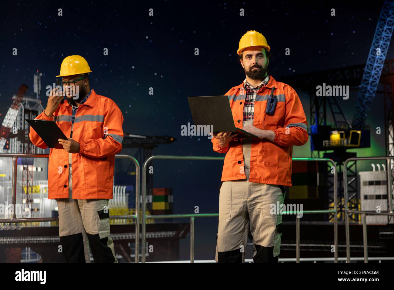 Technician on offshore platform using laptop to control subsea systems ...