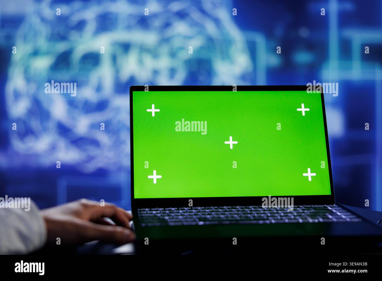 Admin using green screen device for artificial intelligence computing simulating human brain through self learning algorithms. Employee with chrome key laptop, working with AI deep neural networks Stock Photo