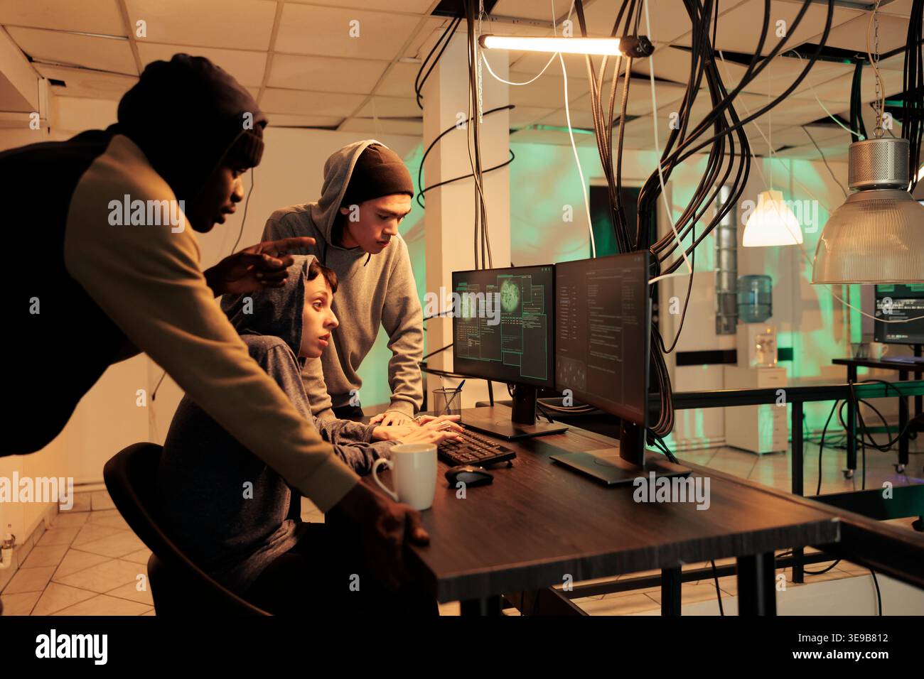 Team of encryption specialists trying to plant computer malware, fixing computer system cyberattack. Cyber criminals coding program script to break into network, cyberterrorism. Stock Photo