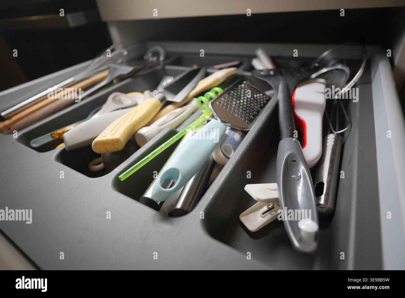 Kitchen utensils in a drawer during daytime Stock Photo