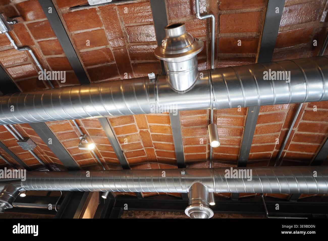View of pipes on ceiling in a restaurant setting Stock Photo