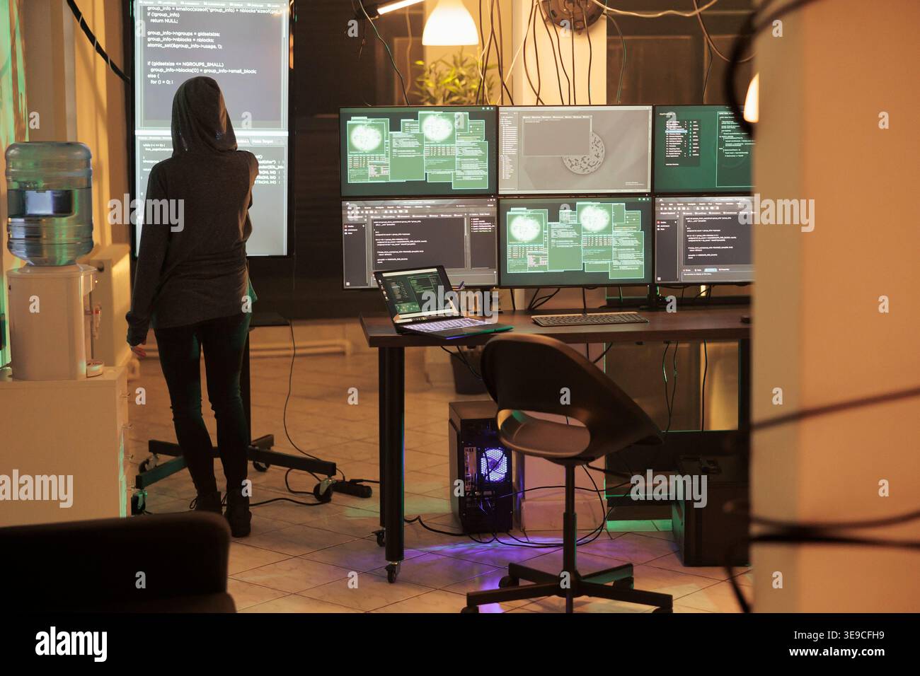 Young hacker analyzing script to crack security system and access network, trying to break into database. Spy planning computer malware and spyware, using virus to steal passwords. Stock Photo