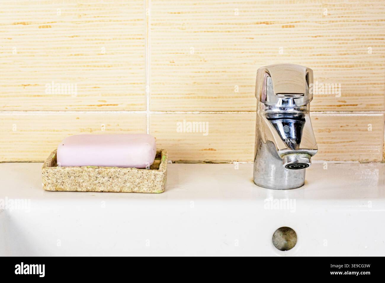 Mold and cracked silicone on the tile grout in the bathroom. Renovation. Stock Photo