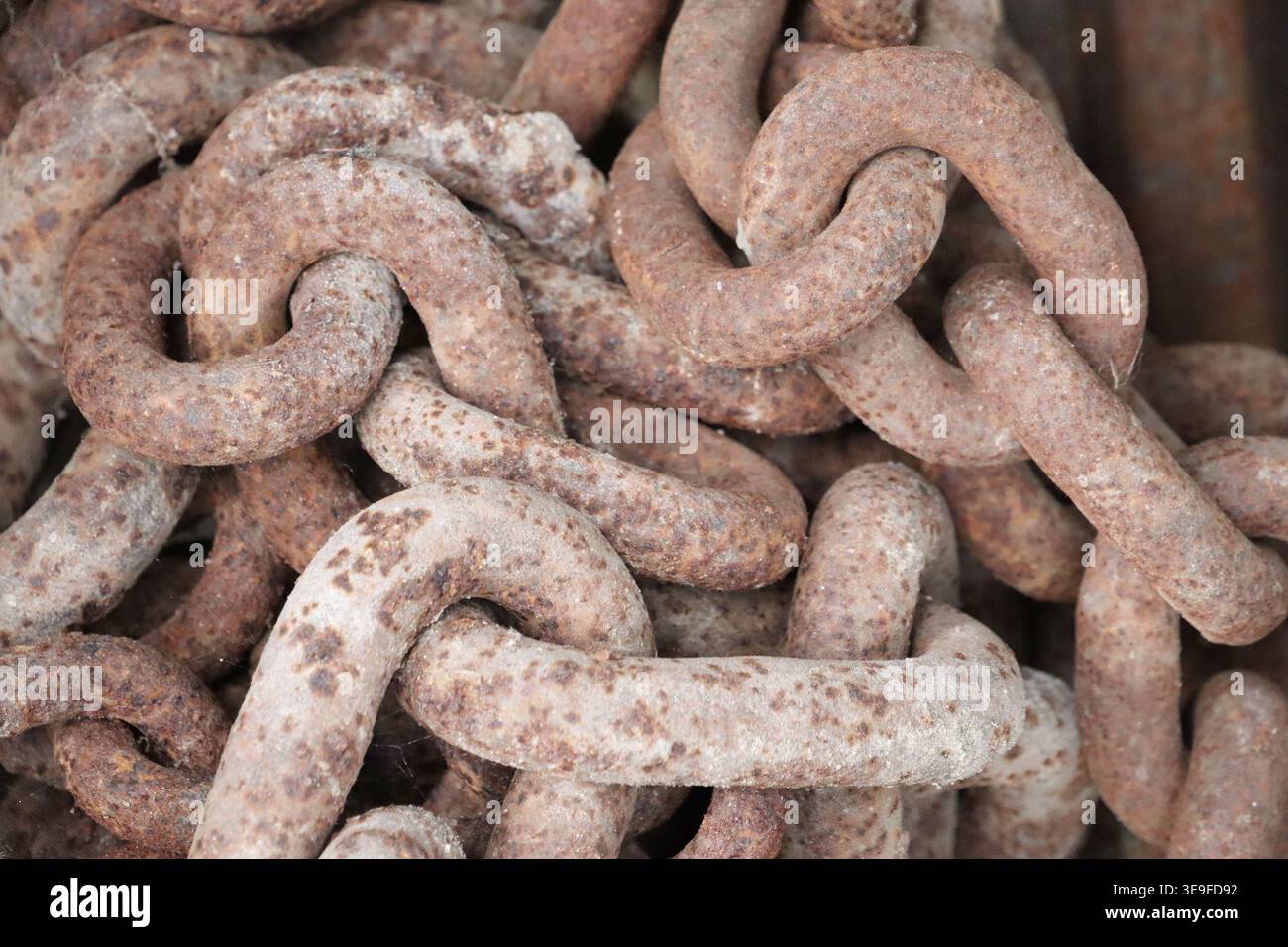 Old, rusty chains close up in an image. Stock Photo