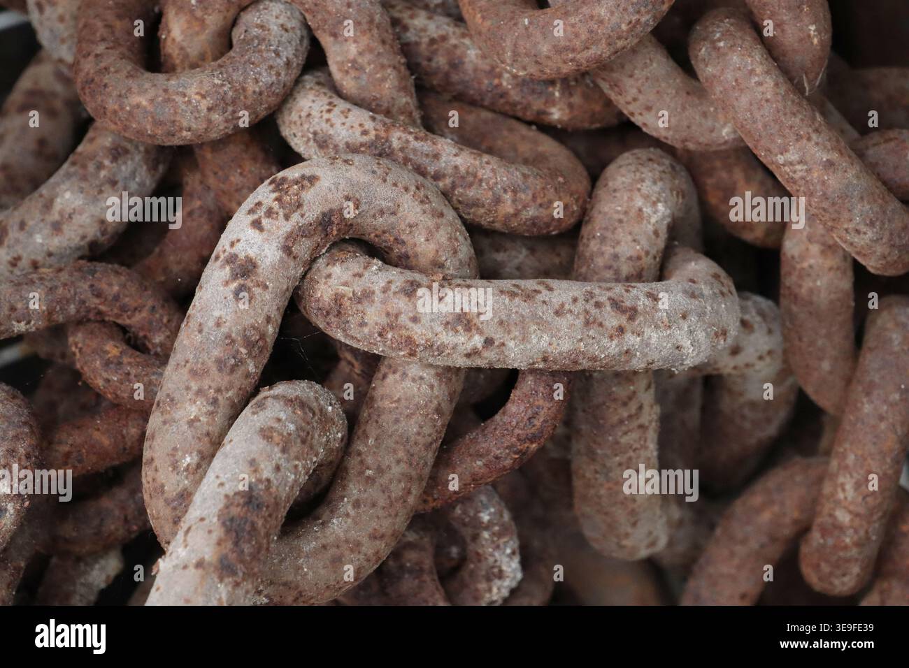 Old, rusty chains close up in an image. Stock Photo